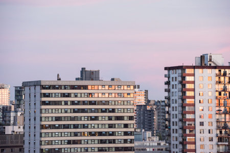 Office buildings in city against sky during sunsetの写真素材