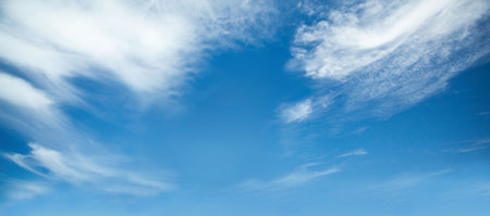 clear blue sky is showing thin wispy clouds in full-frame flat design with open air vibe. Heaven, atmosphere, tranquility, vastness, serenity, minimalism, outdoorの写真素材