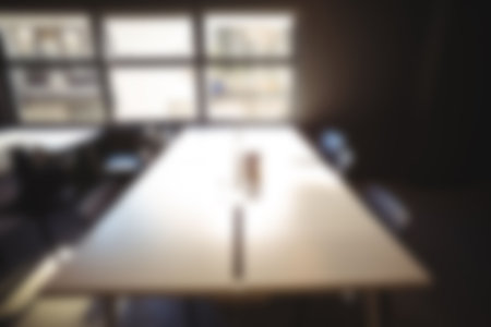 Defocused image of table and chairs in brightly lit roomの写真素材