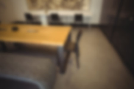 Defocused image of table and empty chairs in modern office