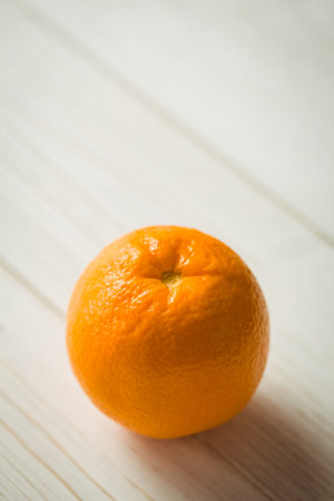 Close-up of orange fruit on wooden tableの写真素材