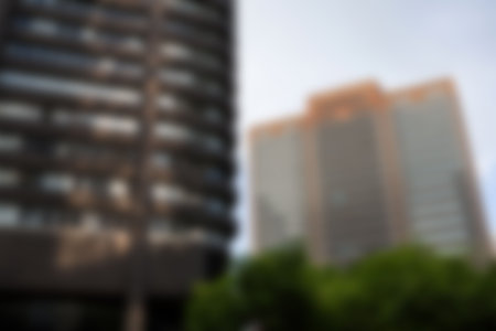 Defocused image of buildings against sky in cityの写真素材