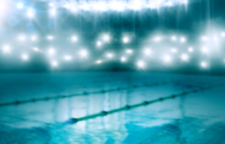 Competitive pool lanes are reflecting overhead lights with floating lane ropes in flat design. Aquatic, stadium, reflection, infrastructure, sport, aquatic center, blueの写真素材