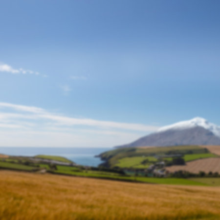 Idyllic image of field and mountain against skyの写真素材