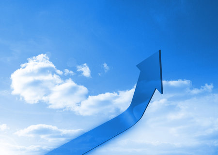 Large glossy blue arrow is curving upward in digital rendering of bright sky with scattered clouds. Progress, growth, direction, innovation, motivation, success, navigationの写真素材
