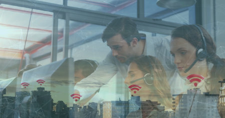 Leaning supervisor guiding headset-wearing agents at glass-paneled office desk, with Wi-Fi overlay....