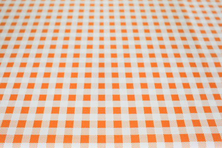 Full frame shot of orange checked pattern fabricの写真素材