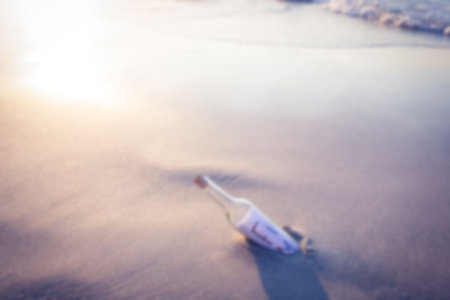Meassage in a bottle on sunny sandの写真素材