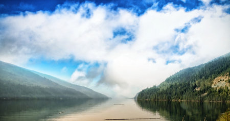 Scenic view of river amidst mountains against cloudy skyの写真素材