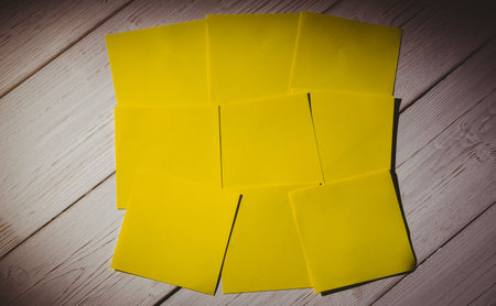 Close-up of yellow papers on wooden floor