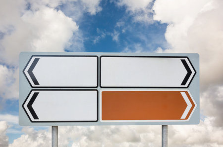 Blank sign posts against cloudy skyの写真素材