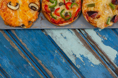 Overhead cropped image of pizzas on weathered wooden tableの写真素材
