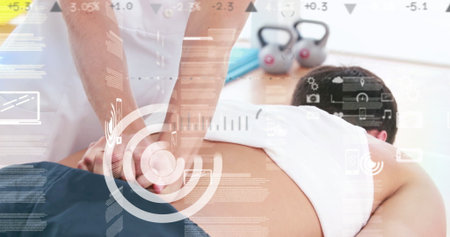 Female therapist pressing down on client back in spa room, with kettlebells and data overlay. Wellness, therapy, relaxation, assistance, sports, fitness, healthの写真素材