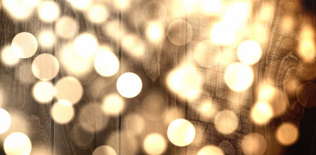 Showing interior wooden planks glowing with defocused golden bokeh light circles in flat design. Warmth, rustic, ambiance, cozy, tranquility, illumination, decorativeの写真素材