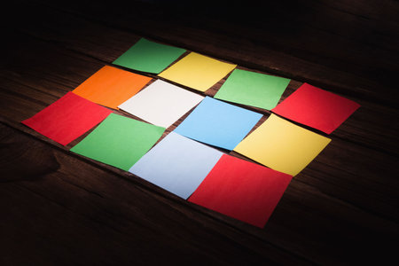 High angle view of colorful papers on wooden flooring