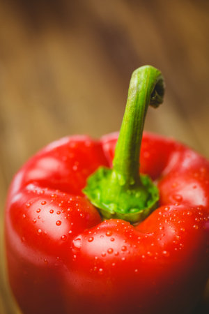 Close-up of fresh red pepper on wooden tableの写真素材