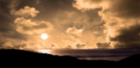 Scenic view of beach against cloudy sky during sunsetの写真素材