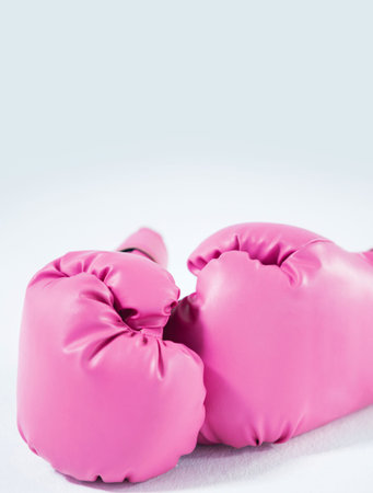 Pink boxing gloves against white backgroundの写真素材
