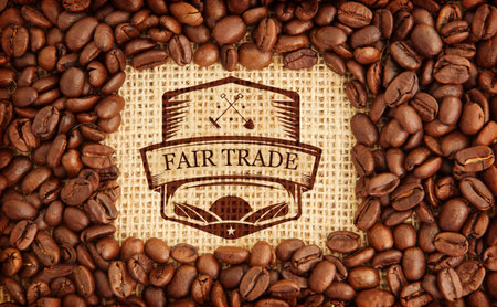 Centering fair trade emblem stamp on burlap in flat lay illustration, framing coffee bean ring. Craftsmanship, sustainability, organic, rustic, environmental, ethics, artisanalの写真素材