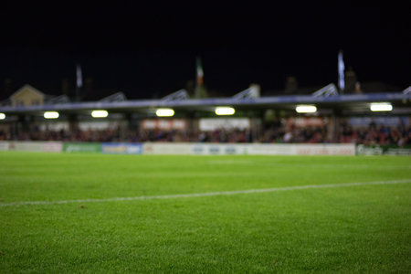 Empty soccer pitch is being shown in flat design featuring white line floodlights stands ad boards. Stadium, athletic, recreational, vibrant, competitive, outdoor, energeticの写真素材