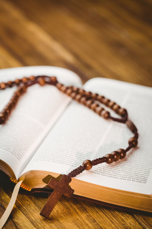 Close-up of rosary beds on bible bookの写真素材
