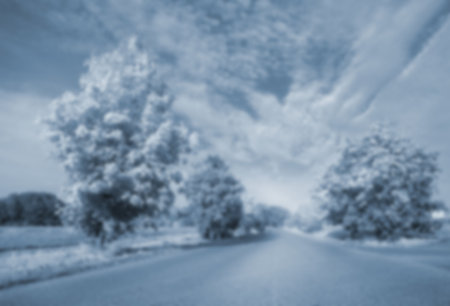 View of an empty tarmac country road along trees and landscapeの写真素材