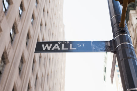 Wall Street sign is being shown in flat design, with metal lamppost and office facade. Urban,...