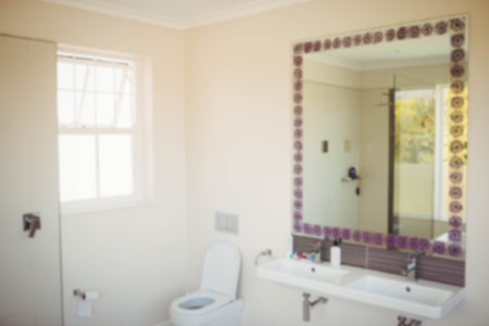 Mirror mounted on wall in bathroom at homeの写真素材