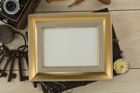 Photo frame, clock, keys, camera on wooden table, Close-up