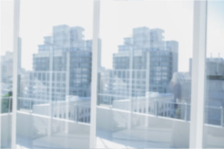 balcony doorway is being shown in flat design, featuring glass sliders, railing and city skyline. Contemporary, cityscape, minimalist, urban, architecture, daylight, scenicの写真素材