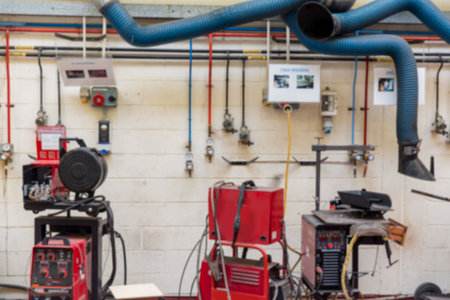 Central red welding machines are standing in flat design workshop, with gas pipes and blue ducts. Industrial, craftsmanship, machinery, metallic, technical, manufacturing, industrial designの写真素材