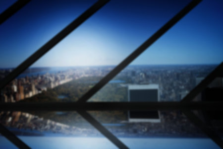 Digital image of city against blue sky seen through metal grate at buildingの写真素材