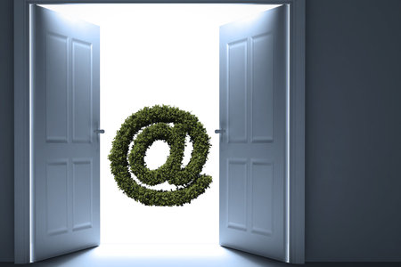 At sign against white background amidst open doorの写真素材