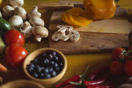 Berries in bowl and mushrooms on table at homeの写真素材