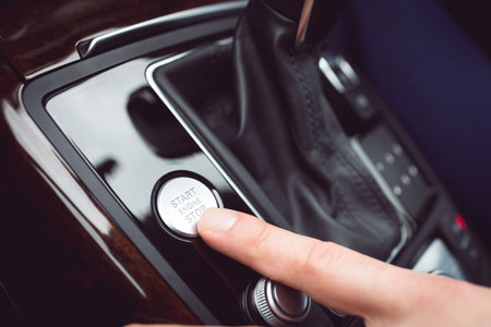 Man pressing start button in carの写真素材