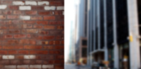 Composite flat design is showing weathered red brick facade merging with blurred urban street scene....