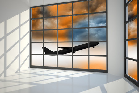 Airplane flying over orange sky past windowの写真素材