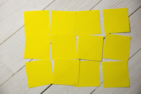 Directly above shot of yellow papers on wooden surfaceの写真素材