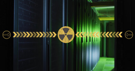 Showing yellow radiation icon with chevron and circle arrows in data center with green-lit servers. Technology, cybersecurity, data storage, industrial, futuristic, network, digital infrastructureの写真素材
