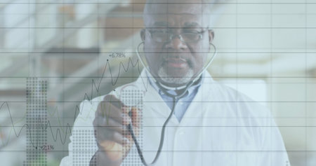 Senior doctor analyzing data on glass panel with overlay in lab, wearing lab coat and stethoscope. Medical, analytics, professional, futuristic, research, healthcare, scienceの写真素材