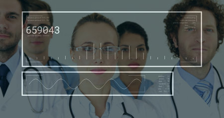 Standing healthcare team wearing lab coats and stethoscopes in corridor, displaying HUD graphics. Medical staff, teamwork, professional, innovation, clinical, biotechnology, healthcareの写真素材