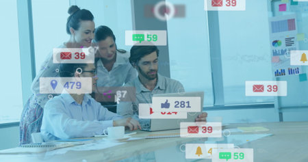 Collaborating four coworkers analyzing laptop social media icons in meeting room, with coffee cups....