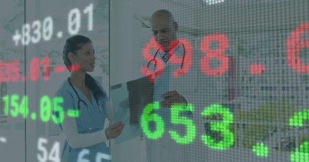 Scrub nurse, lab coat doctor reviewing radiograph on screen in clinic with stethoscopes, stock data....