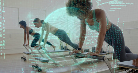 Performing plank exercises women wearing fitness trackers on reformers in studio, with code overlay. Fitness, wellness, strength, modern, movement, technology, healthの写真素材