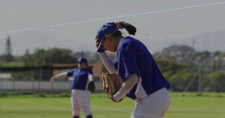 Adjusting cap, woman baseball player in blue uniform standing on field, with glove, copy space. Athletic, team spirit, outdoor, competitive, active, training, recreationalの写真素材