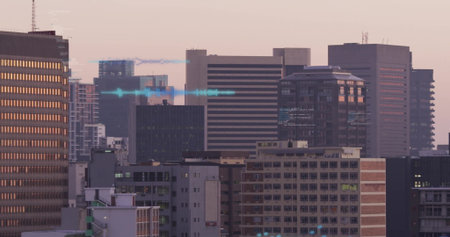 Displaying high-rise towers reflecting sunset glow at city skyline, with construction crane. Skyscrapers, urban landscape, modern architecture, cityscape, sunset lighting, city planning, reflective surfacesの写真素材