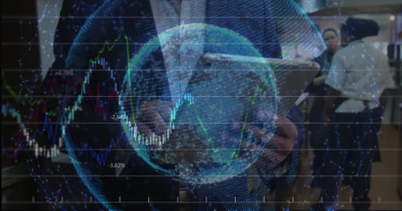 Analyzing financial charts and holographic globe, Asian executive standing at workspace with tablet....
