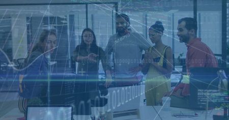 Collaborating professionals in business attire analyzing data in office, with monitors and laptop....