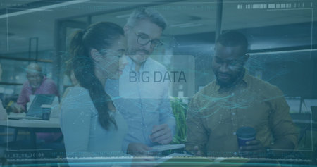 Gathering trio of office professionals viewing tablet at open-plan office, with BIG DATA hologram. Technology, collaboration, innovation, modernity, teamwork, digital, workplaceの写真素材