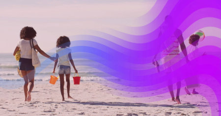 Walking family carrying plastic buckets on beach at low tide, with inflatable ball and striped tote. Family, beach, outdoor, leisure, relaxation, coastal, natureの写真素材